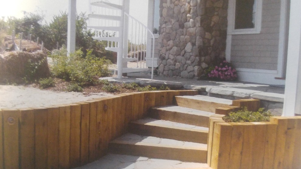 Example of a small beach style concrete curved staircase design in Boston with wooden risers