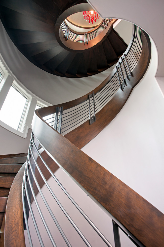 На фото: огромная винтовая деревянная лестница с деревянными ступенями