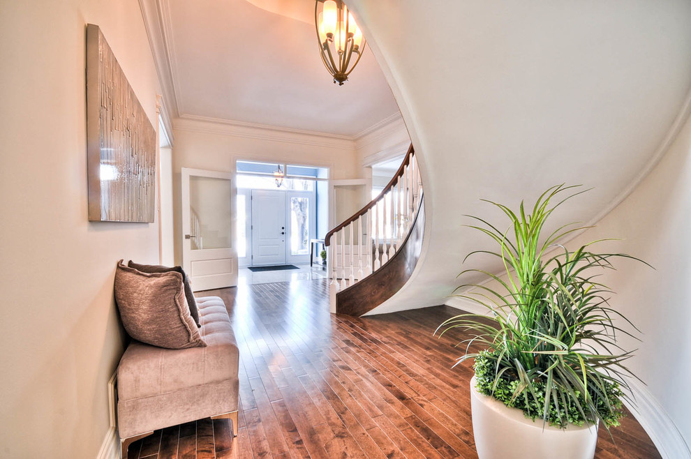 Example of a mid-sized transitional wooden curved staircase design in Ottawa with wooden risers