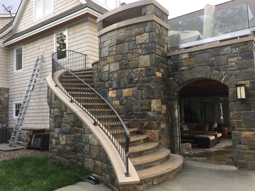 Staircase - mid-sized craftsman concrete curved metal railing staircase idea in Detroit with concrete risers