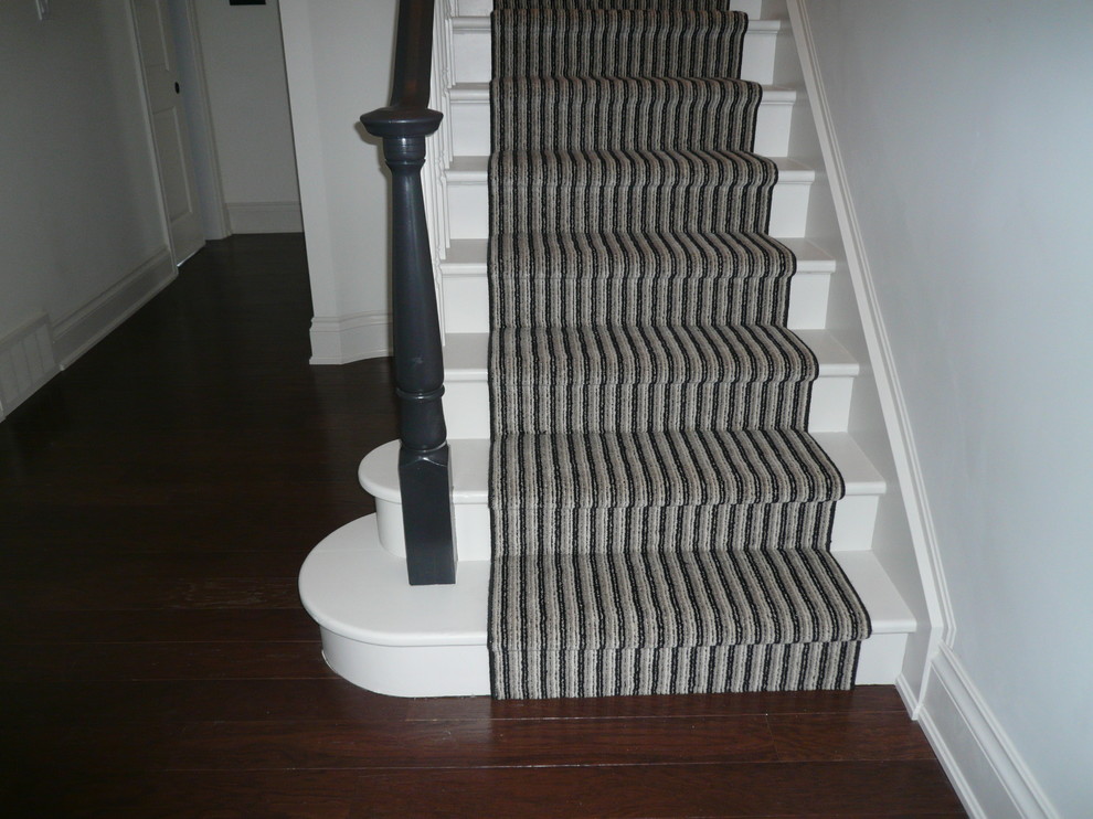 Medium sized classic painted wood curved staircase in Ottawa with painted wood risers.