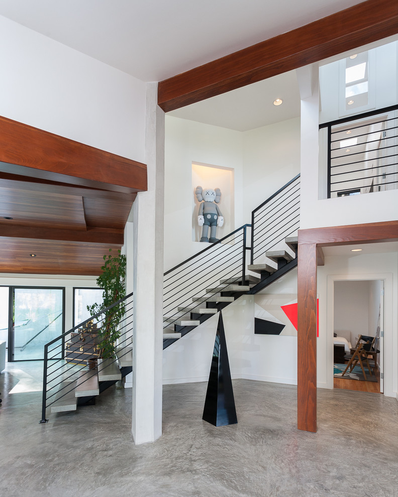 This is an example of a contemporary concrete l-shaped staircase in Los Angeles with open risers.