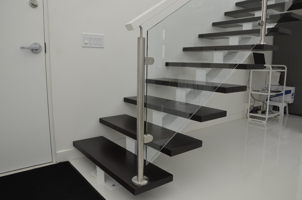 Mid-sized trendy wooden straight open and glass railing staircase photo in Other