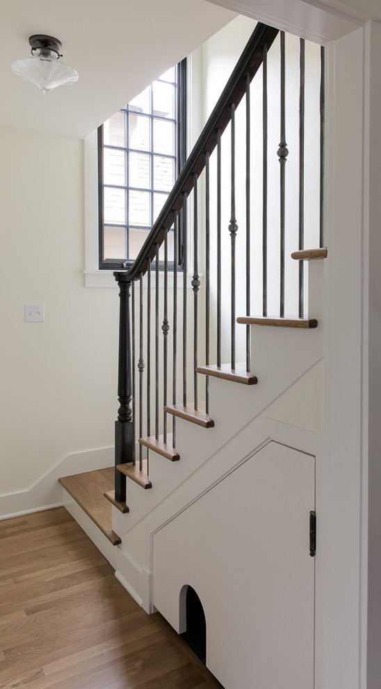 Example of a transitional wooden straight staircase design in Seattle with painted risers