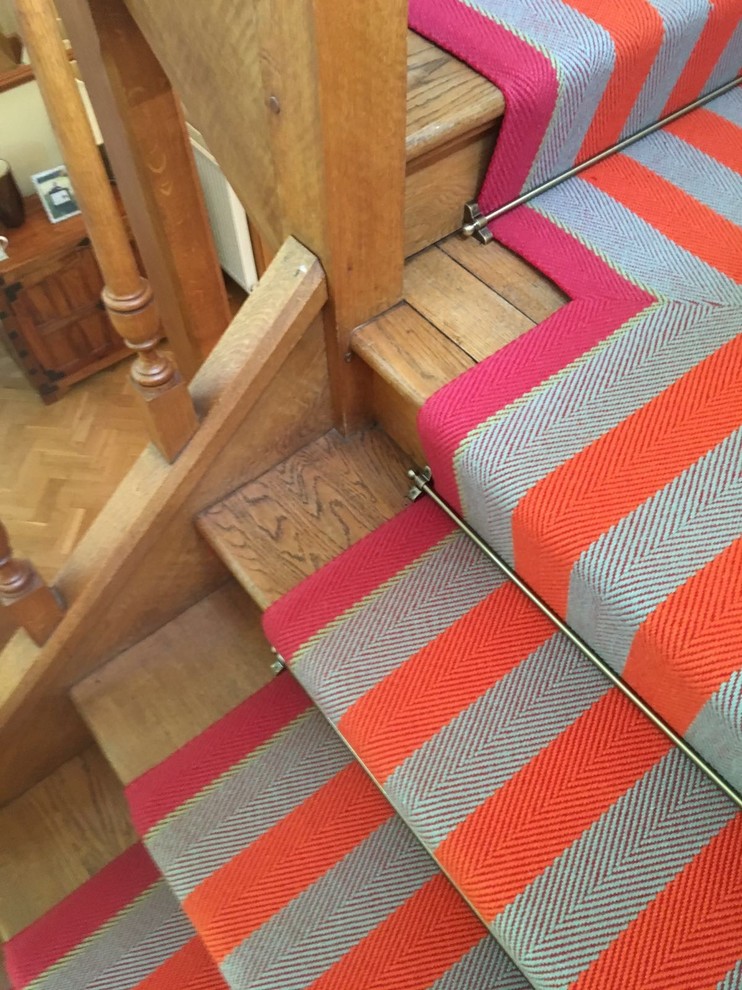 This is an example of a medium sized traditional carpeted l-shaped staircase in Surrey with carpeted risers.