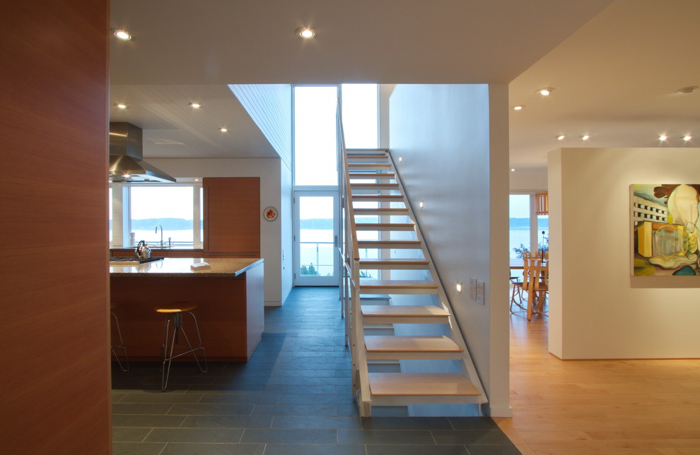 Design ideas for a modern wood straight staircase in Toronto with open risers.