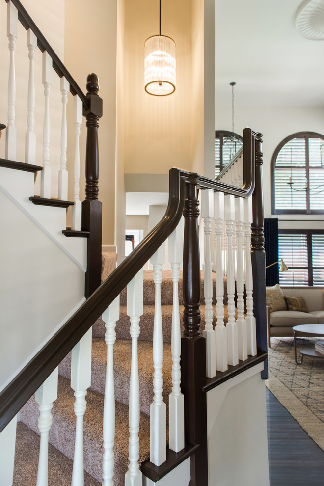 Inspiration for a medium sized traditional carpeted l-shaped wood railing staircase in St Louis with carpeted risers.