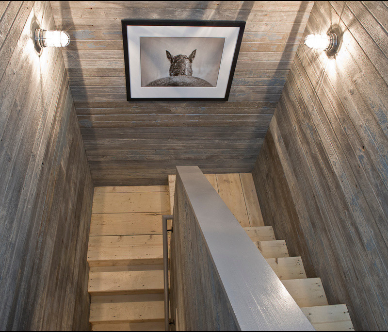 Immagine di una scala a "L" contemporanea di medie dimensioni con pedata in legno e alzata in legno