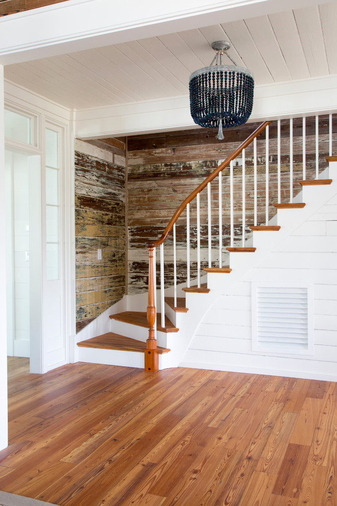 Staircase - coastal wooden curved staircase idea in Charleston with painted risers