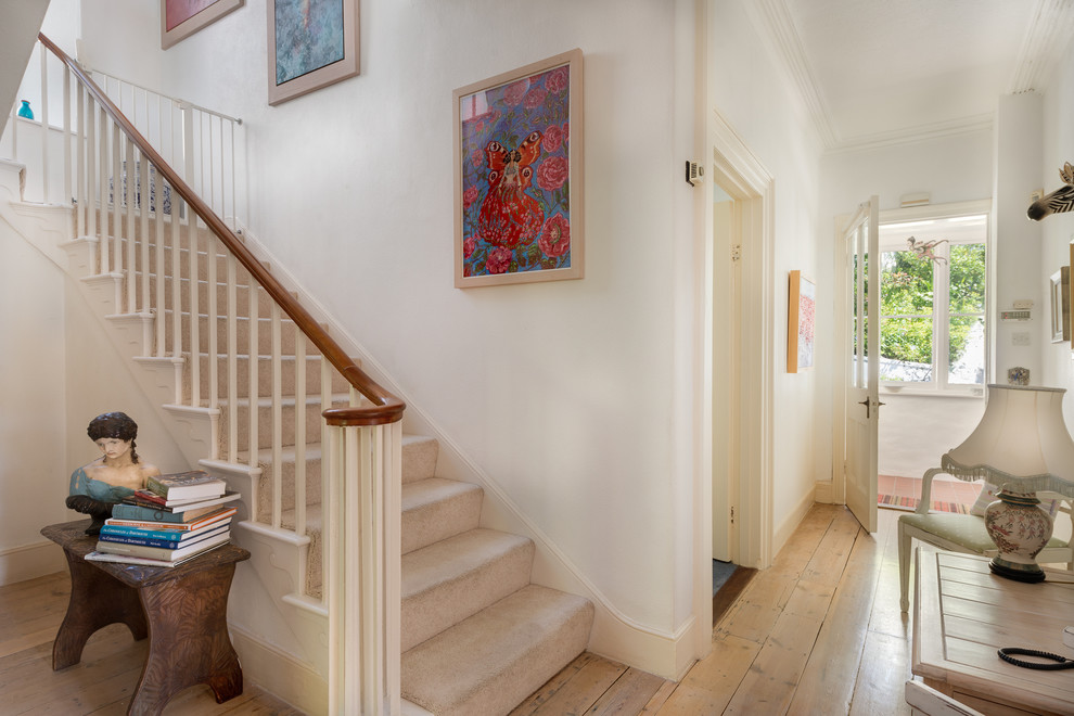Example of a classic carpeted l-shaped staircase design in Devon with carpeted risers