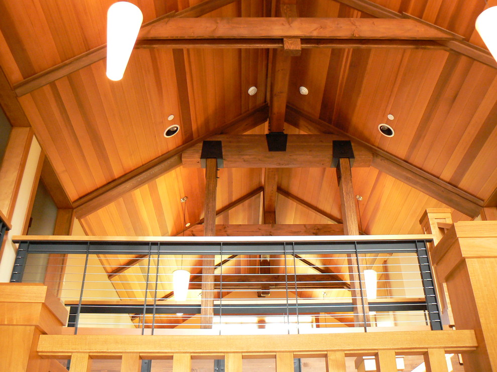 This is an example of a medium sized rustic carpeted u-shaped staircase in Seattle with carpeted risers.