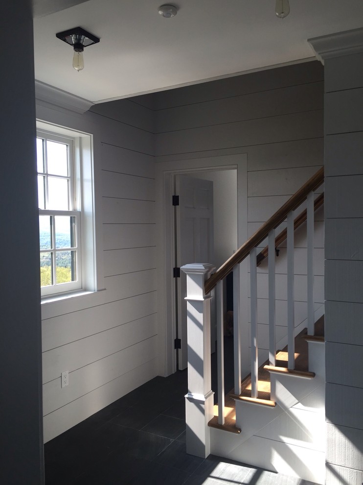 Inspiration for a mid-sized cottage wooden straight staircase remodel in Burlington with painted risers