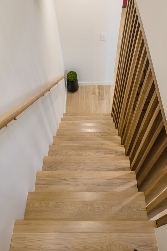 Design ideas for a medium sized contemporary wood straight staircase in Los Angeles with wood risers.