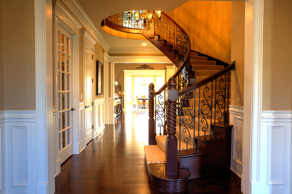 This is an example of a classic wood curved staircase in Chicago with wood risers.