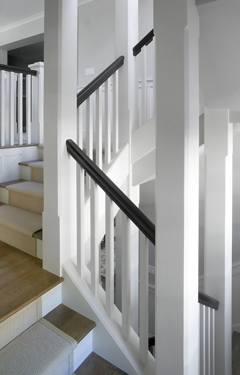 Mid-sized elegant wooden u-shaped mixed material railing staircase photo in Grand Rapids with painted risers