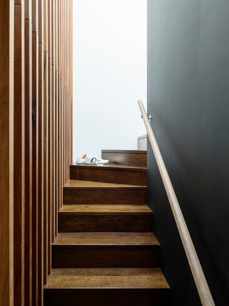 Small minimalist wooden curved staircase photo in Sydney with wooden risers