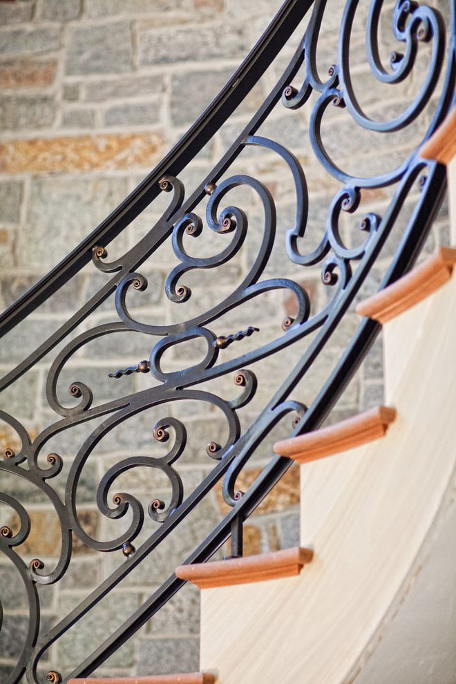 Inspiration for a large mediterranean wood curved staircase in Philadelphia with painted wood risers.
