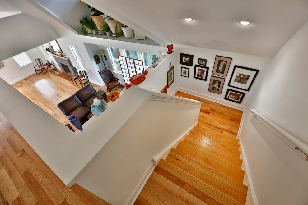 Photo of a medium sized eclectic wood u-shaped staircase in New York with painted wood risers.