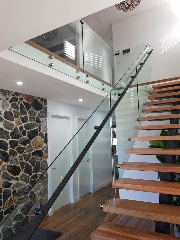 Trendy wooden l-shaped metal railing staircase photo in Sydney
