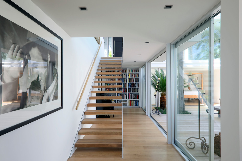 Inspiration for a mid-sized contemporary wooden straight open staircase remodel in Auckland