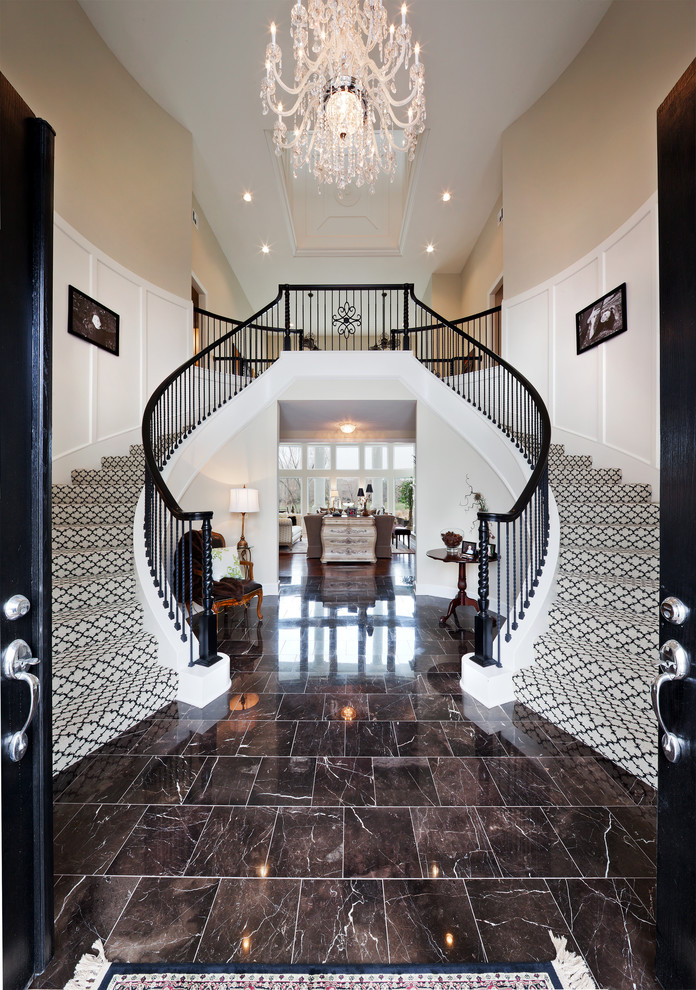 Example of a classic carpeted curved staircase design in Kansas City with carpeted risers