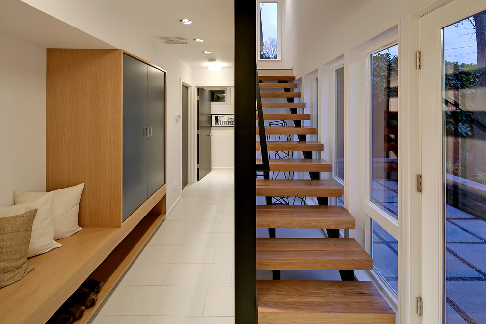 Trendy wooden straight open and metal railing staircase photo in Seattle