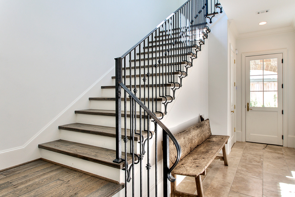 Пример оригинального дизайна: лестница в стиле неоклассика (современная классика) с деревянными ступенями и металлическими перилами