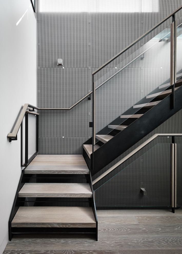 Foto de escalera en L contemporánea sin contrahuella con escalones de madera