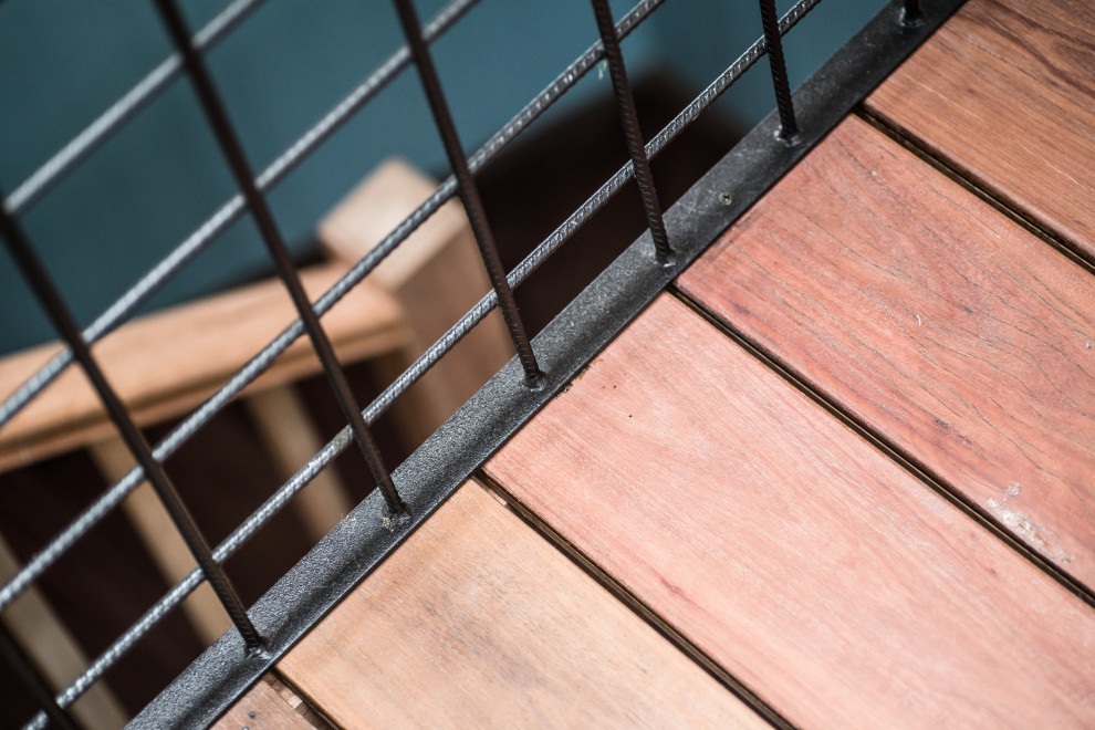 На фото: п-образная деревянная лестница среднего размера в современном стиле с деревянными ступенями и перилами из смешанных материалов с