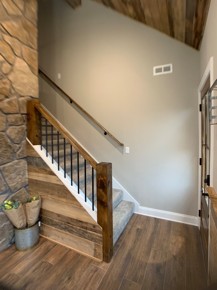 Inspiration for a medium sized rustic carpeted straight wood railing staircase in Chicago with carpeted risers.