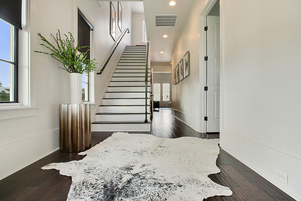 Design ideas for a contemporary wood straight staircase in New Orleans with painted wood risers.