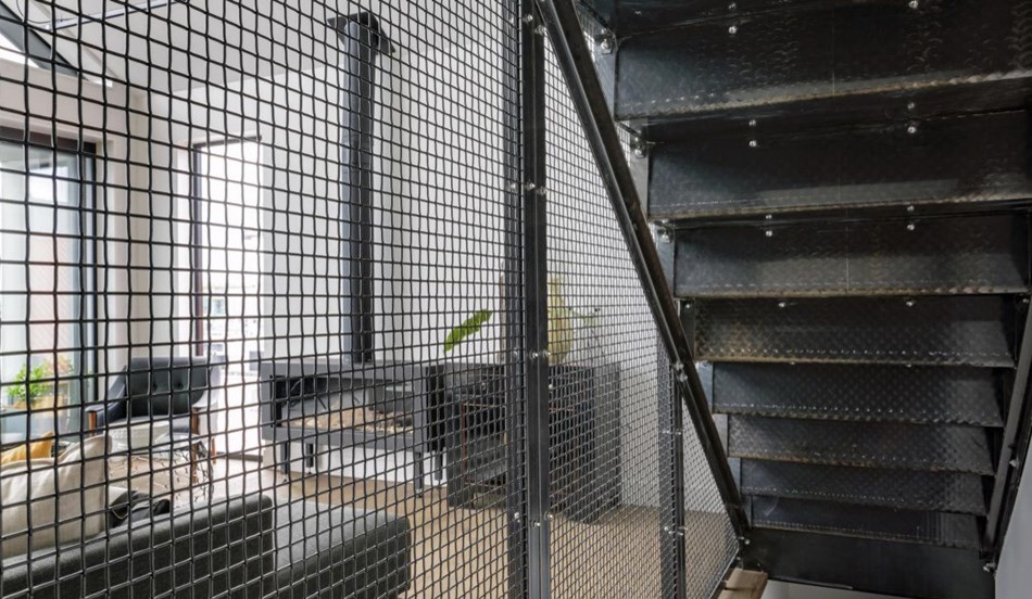 Example of an urban metal straight metal railing staircase design in Auckland with metal risers