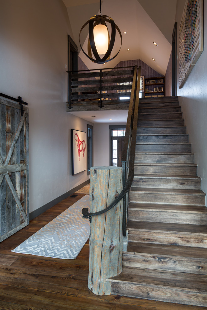 Inspiration for a rustic straight staircase remodel in Other