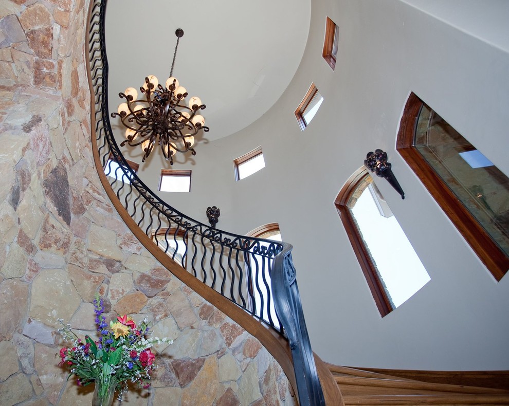 Design ideas for a mediterranean wood spiral staircase in Austin with wood risers.