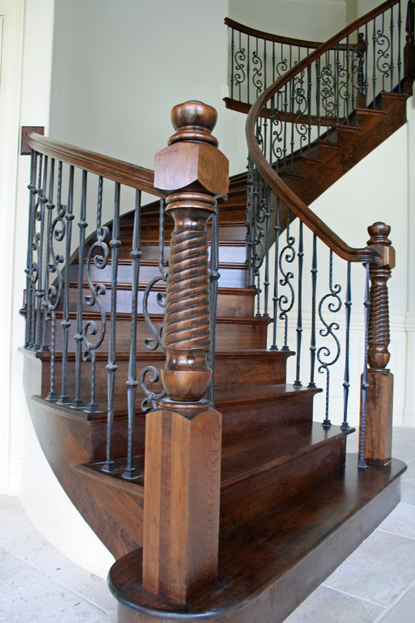 Example of a large classic wooden curved mixed material railing staircase design in Chicago with wooden risers