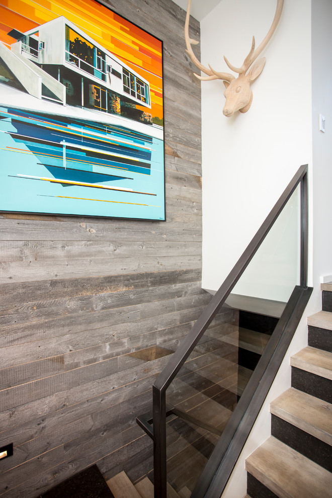 This is an example of a contemporary wood metal railing staircase in Salt Lake City with open risers.