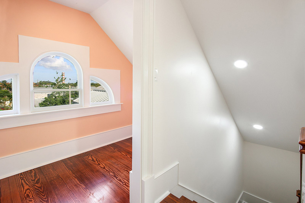 This is an example of a medium sized traditional wood wood railing staircase in New Orleans with wood risers.