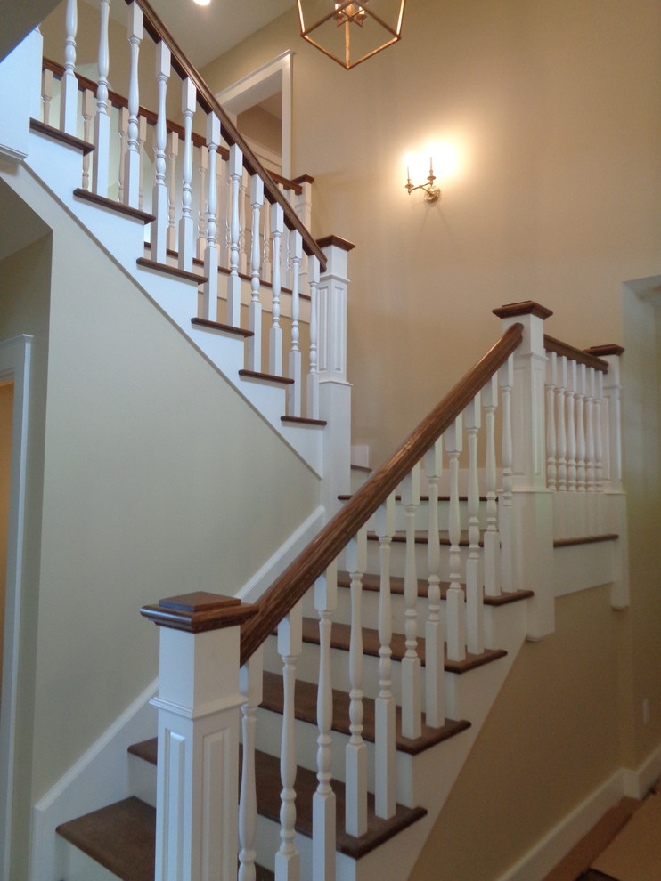 Design ideas for a medium sized rustic wood u-shaped wood railing staircase in Other with painted wood risers.