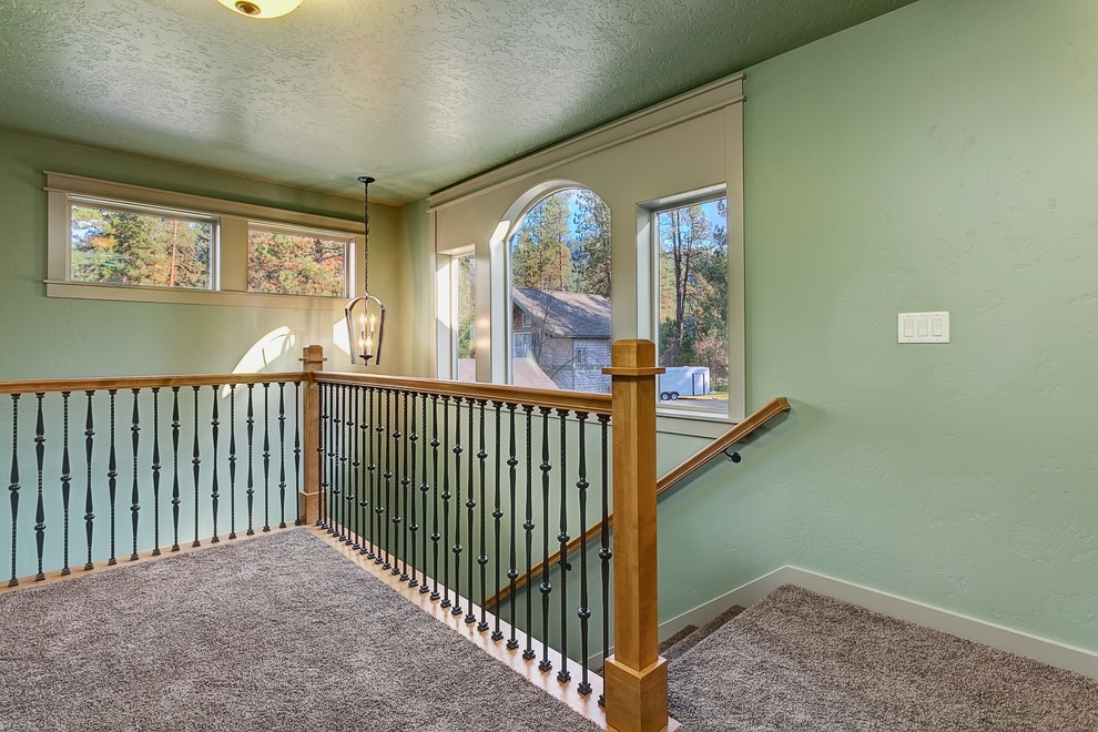 Mid-sized arts and crafts carpeted l-shaped staircase photo in Boise with carpeted risers