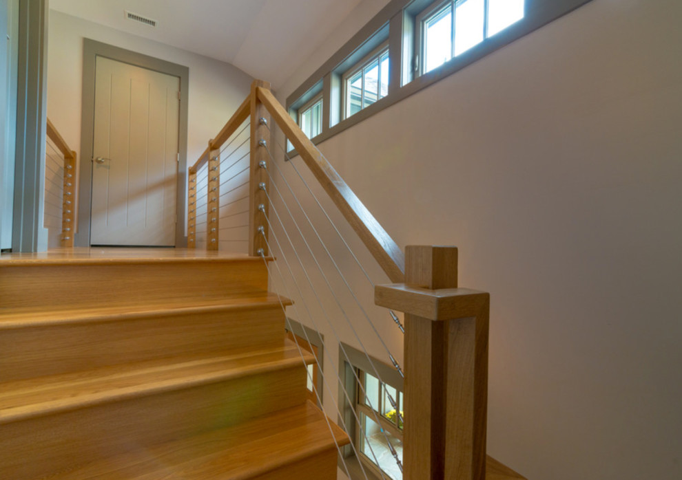 Example of a mid-sized arts and crafts wooden u-shaped staircase design in Other with wooden risers