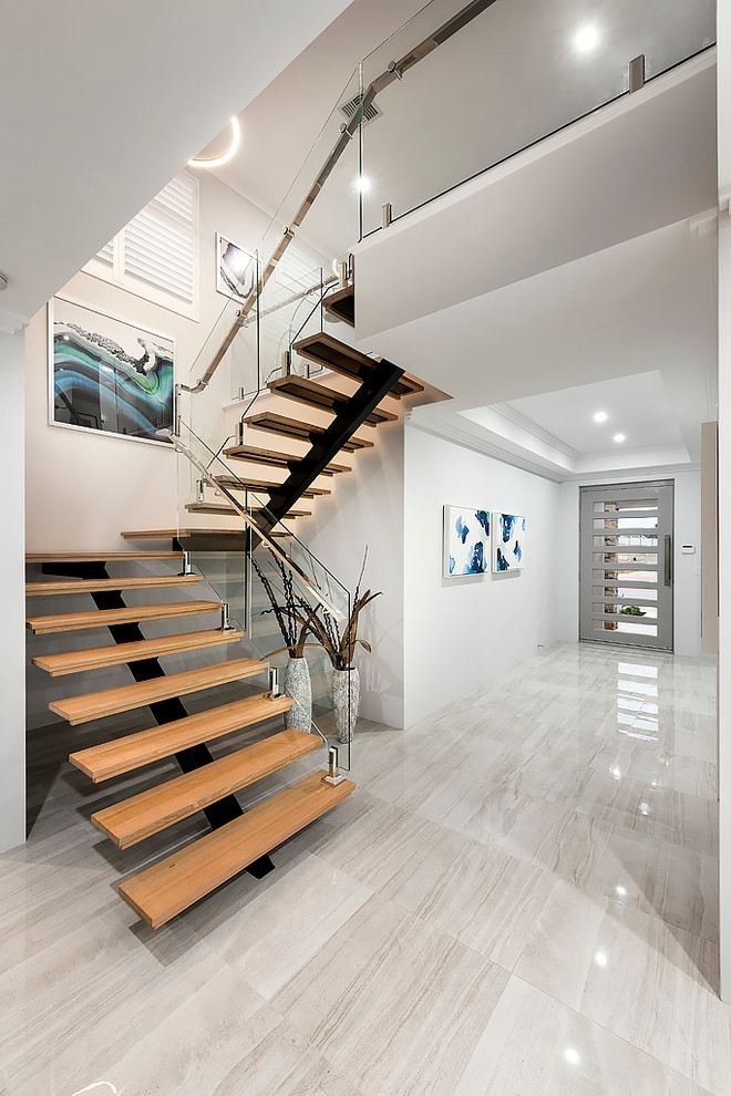 Свежая идея для дизайна: п-образная лестница среднего размера в современном стиле с деревянными ступенями без подступенок - отличное фото интерьера