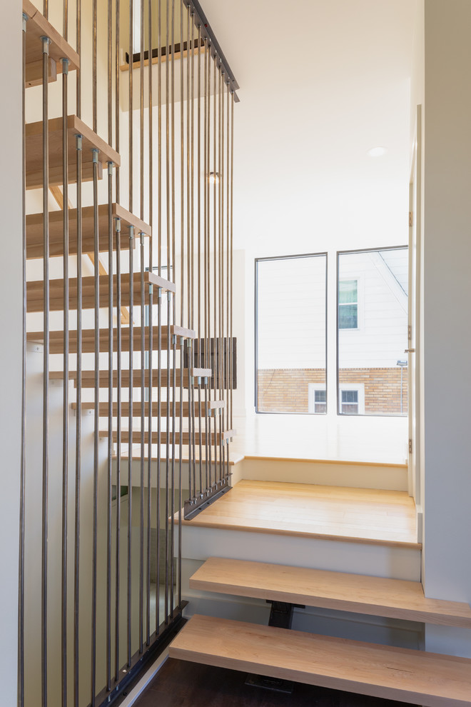 Inspiration for a large modern wooden floating open and metal railing staircase remodel in Detroit
