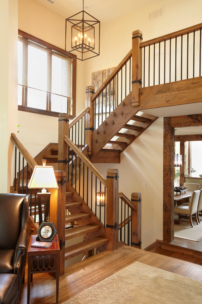 Inspiration for a large rustic wood u-shaped staircase in Toronto with open risers and feature lighting.