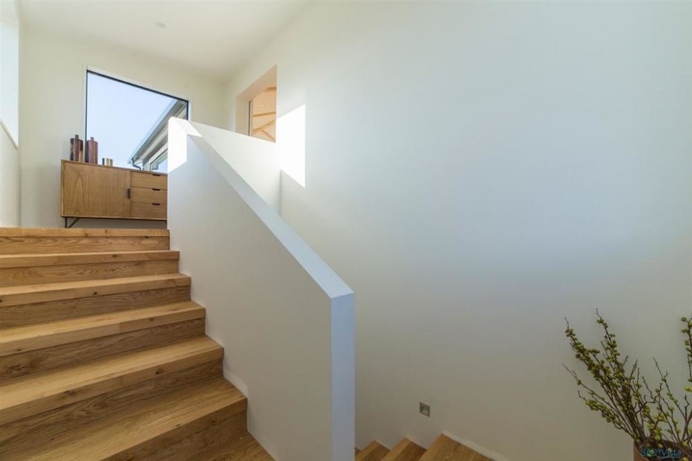 Example of a mid-sized cottage wooden staircase design in Other with wooden risers