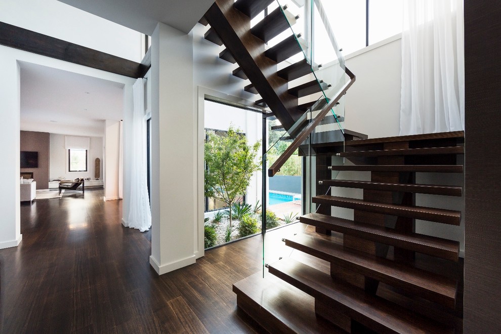 Large modern u-shaped glass railing staircase in Melbourne.