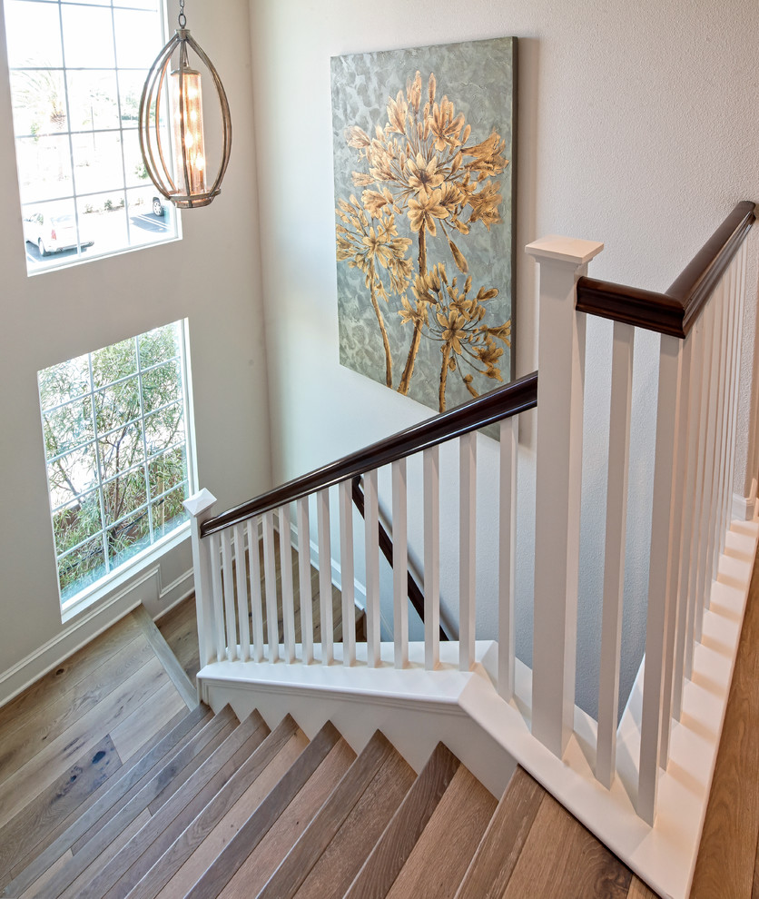 Idée de décoration pour un escalier courbe tradition de taille moyenne avec des marches en bois, des contremarches en bois et un garde-corps en bois.