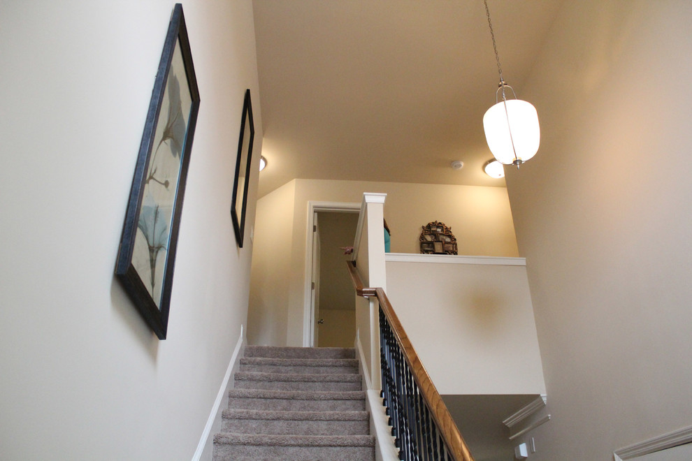 This is an example of a traditional carpeted straight mixed railing staircase in Atlanta with carpeted risers.