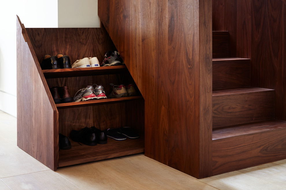 Contemporary wood staircase in London with wood risers and under stair storage.