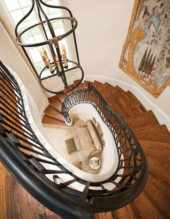 Inspiration for a large transitional wooden curved wood railing staircase remodel in Denver with wooden risers