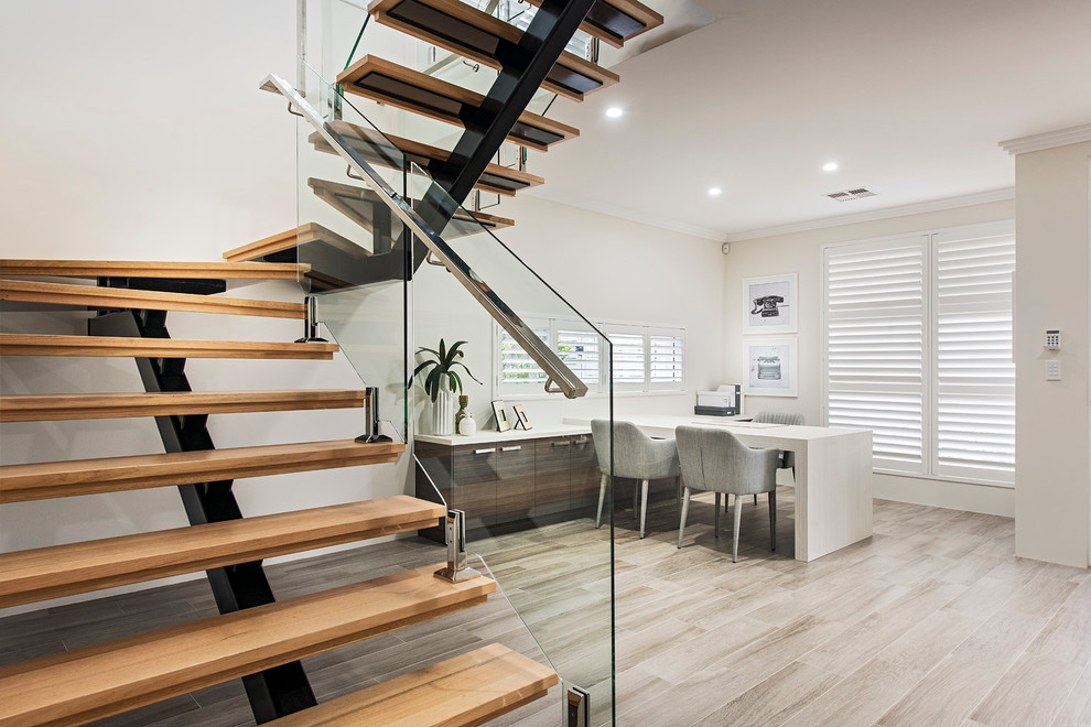 Design ideas for a medium sized contemporary wood u-shaped staircase in Perth with open risers.